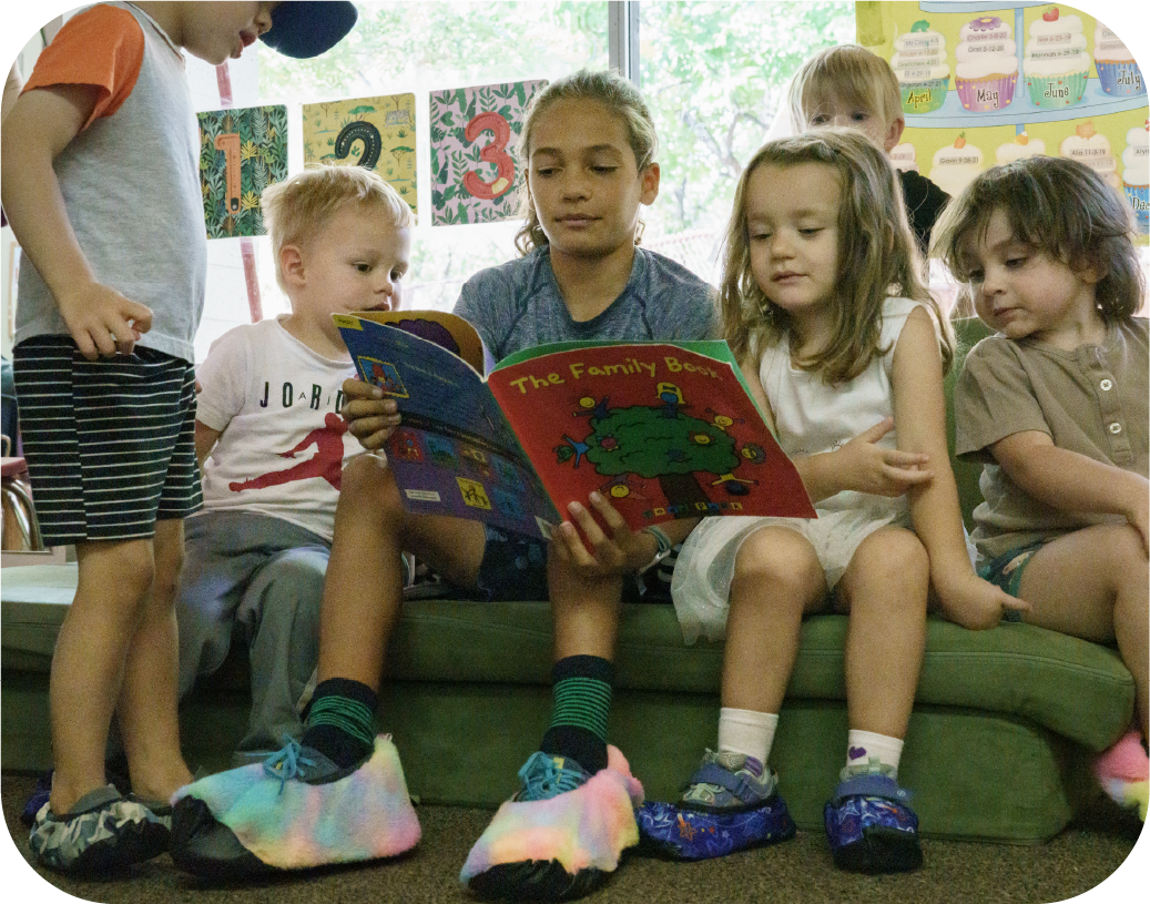 Yannick reading a book to kids wearing ShoeShoes