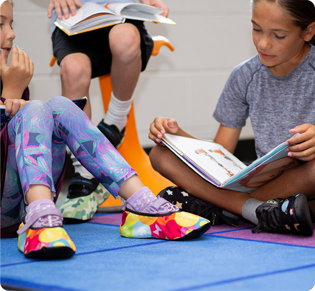 kids sitting on floor wearing ShoeShoes